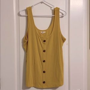 Mustard yellow tank top with brown buttons.